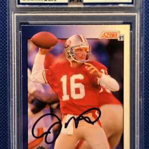 May include: A Joe Montana trading card, graded and authenticated. The card features a photo of Montana in a red jersey with the number 16, throwing a football. The card is encased in a protective holder.