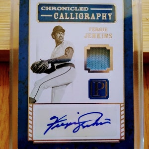 May include: A baseball card featuring Fergie Jenkins, a baseball player. The card is blue and gold with a white background. The card has a picture of Jenkins pitching, his signature, and a piece of his jersey. The card is titled "Chronicled Calligraphy".