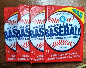 May include: Four vintage baseball card packs. Each red pack features a baseball graphic with the words "Major League Baseball" in blue. The packs also include the text "Bubble Gum with Cards" and the year "1988".