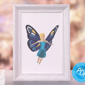 May include: Cross stitch pattern featuring a fairy with blue wings and a blue dress. The fairy has blonde hair and is flying. The pattern is in a white frame and there is a blue and white "Instant Download PDF Cross Stitch Pattern" label in the bottom right corner.