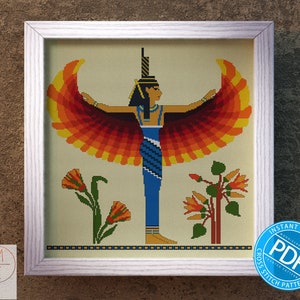 May include: Cross stitch pattern featuring a colorful depiction of an Egyptian goddess with outstretched wings. The goddess is wearing a blue dress and a crown. The pattern includes flowers and a beige background.