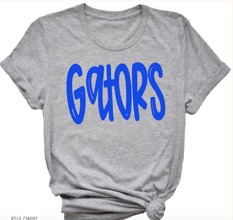 May include: A gray t-shirt with the word "GATORS" printed in blue.