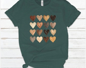 May include: A teal green t-shirt with a design of 16 different colored hearts. The hearts are arranged in a 4x4 grid.