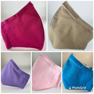 May include: Five fabric face masks in different colors: pink, purple, blue, brown, and magenta. The masks are all made of a soft, breathable fabric and have a simple, modern design.