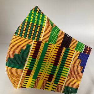 May include: A yellow, green, and brown patterned face mask. The mask is made of fabric and has a geometric design.