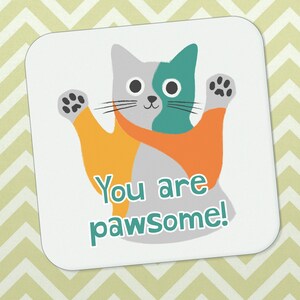 May include: A white card featuring a cartoon cat wearing a teal and orange scarf. The cat is waving with its right paw and the text "You are pawsome!" is written below the cat.