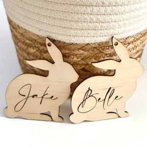 May include: Two wooden bunny-shaped ornaments with the names "Jake" and "Belle" engraved on them.