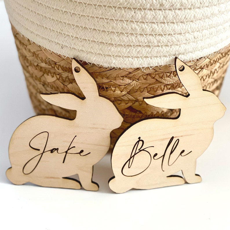 May include: Two wooden bunny-shaped ornaments with the names "Jake" and "Belle" engraved on them.