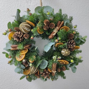 All natural fresh Christmas Winter festive handmade door wreath with artificial rose hips.