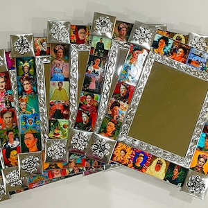 May include: A set of six silver-toned framed mirrors with a collage of colorful images of Frida Kahlo. The frames are decorated with floral designs.