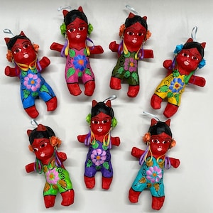 May include: Seven handmade paper mache dolls with red bodies, black hair, and painted floral details. Each doll has a different colored outfit and floral design.