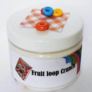May include: A white jar with a white lid and a label that says "Fruit Loop Crunch". The jar is decorated with a red, yellow, and blue cereal loop on a checkered red and white background.