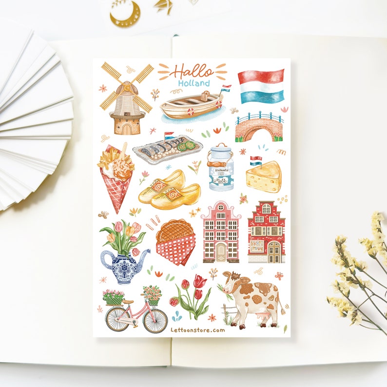 May include: A set of colorful stickers featuring Dutch icons like windmills, clogs, tulips, and houses. The stickers also include a Dutch flag, a boat, a bridge, and a cheese wedge. The text "Hallo Holland" is written in orange and white.