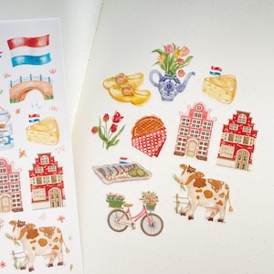 May include: A set of colorful stickers featuring Dutch themes, including houses, clogs, windmills, and a cow. The stickers are perfect for adding a touch of Dutch charm to your planner, journal, or scrapbook.