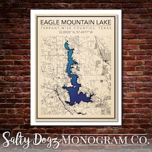 May include: A vintage-style map of Eagle Mountain Lake in Tarrant and Wise Counties, Texas. The map shows the lake in blue and the surrounding roads and streets in black. The coordinates 32.8935° N, 97.4977° W are printed below the lake name.