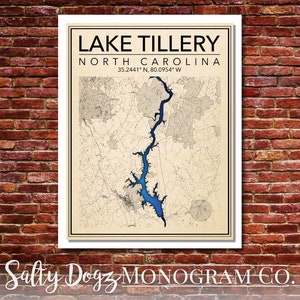 May include: A vintage-style map print of Lake Tillery in North Carolina. The map is in shades of brown and blue, with the lake highlighted in blue. The text "LAKE TILLERY" and "NORTH CAROLINA" is printed in black at the top of the map. The coordinates "35.2441° N, 80.0954° W" are printed below the state name.