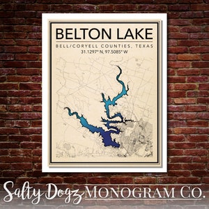 May include: A vintage-style map of Belton Lake in Bell/Coryell Counties, Texas. The lake is highlighted in shades of blue, with the coordinates 31.1297° N, 97.5085° W printed below. The text "Salty Dogz MONOGRAM CO." is printed at the bottom of the map.