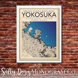 May include: A vintage-style map print of Yokosuka, Japan, with the text "United States Navy Base Yokosuka, Yokosuka, Japan, 35.2906° N, 139.6692° E" and the text "Salty Dogz Monogram Co."