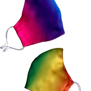 May include: Two rainbow ombre face masks. One mask is a gradient of pink, purple, and blue. The other mask is a gradient of green, yellow, and orange.