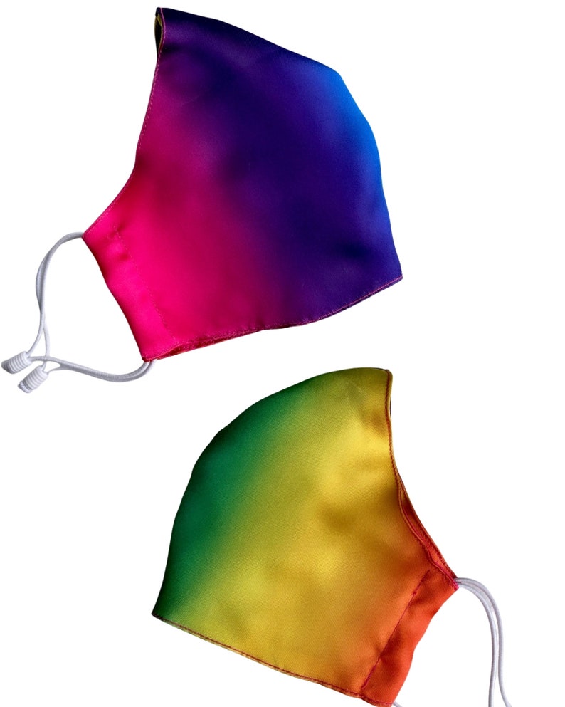 May include: Two rainbow ombre face masks. One mask is a gradient of pink, purple, and blue. The other mask is a gradient of green, yellow, and orange.