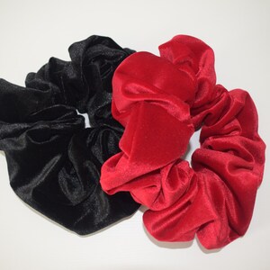 May include: Two velvet scrunchies, one black and one red.