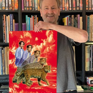 May include: A red and white poster with a collage of images. The poster features a man and a woman in the background, and three jaguars in the foreground. The jaguars are walking on a red and white cloudy sky. The poster is signed "Denis M. Watkins" in the bottom right corner.