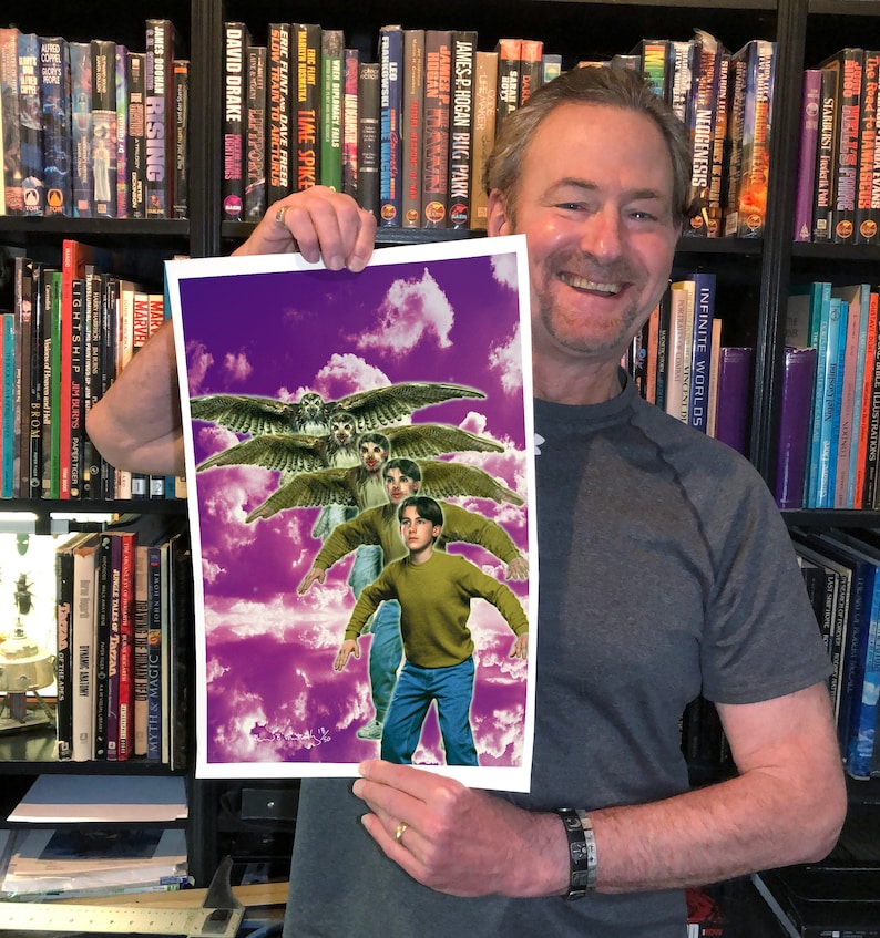 May include: A man holds up a print of a fantasy illustration. The illustration features three figures with wings, flying against a purple and white cloudy sky. The figures are wearing casual clothing and have a whimsical expression.