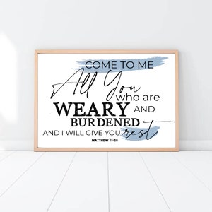 May include: A white framed print with a blue watercolor background and black text that reads "Come to me all you who are weary and burdened and I will give you rest - Matthew 11:28".