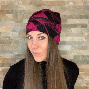 Knit beanie style hat with ponytail holes. image 3