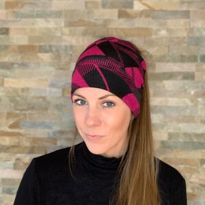 Knit beanie style hat with ponytail holes. image 2