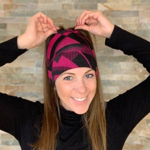 Knit beanie style hat with ponytail holes. image 1