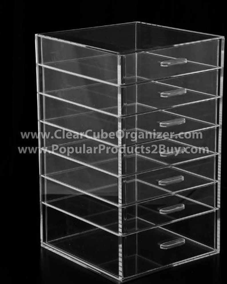 May include: Clear acrylic organiser with six drawers. The organiser is made of clear acrylic and has a modern design. It is perfect for storing small items such as jewellery, makeup, or office supplies.