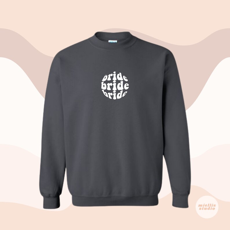 May include: Dark gray sweatshirt with a white circle graphic that says "bride" three times in a retro font.