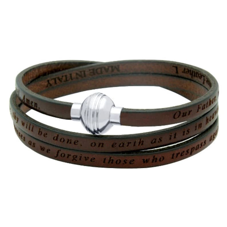 May include: Brown leather wrap bracelet with a silver magnetic clasp. The bracelet has the Lord's Prayer engraved on it. "Our Father, who art in heaven, hallowed be thy name. Thy kingdom come, thy will be done, on earth as it is in heaven. Give us this day our daily bread. And forgive us our trespasses, as we forgive those who trespass against us. And lead us not into temptation, but deliver us from evil. For thine is the kingdom, and the power, and the glory, forever and ever. Amen."