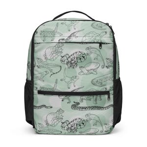 May include: A light green backpack with a black handle and straps. The backpack features a repeating pattern of various reptiles and amphibians in black and white, set against a backdrop of light green circles.