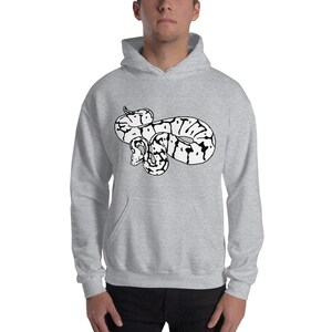 May include: A light gray hooded sweatshirt featuring a black and white graphic of a snake. The snake design is centered on the front of the sweatshirt. The sweatshirt has a kangaroo pocket and a drawstring hood.