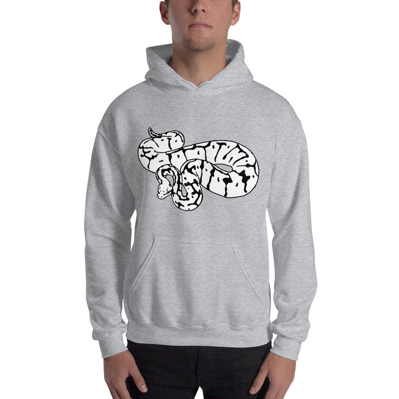 May include: A light gray hooded sweatshirt featuring a black and white graphic of a snake. The snake design is centered on the front of the sweatshirt. The sweatshirt has a kangaroo pocket and a drawstring hood.