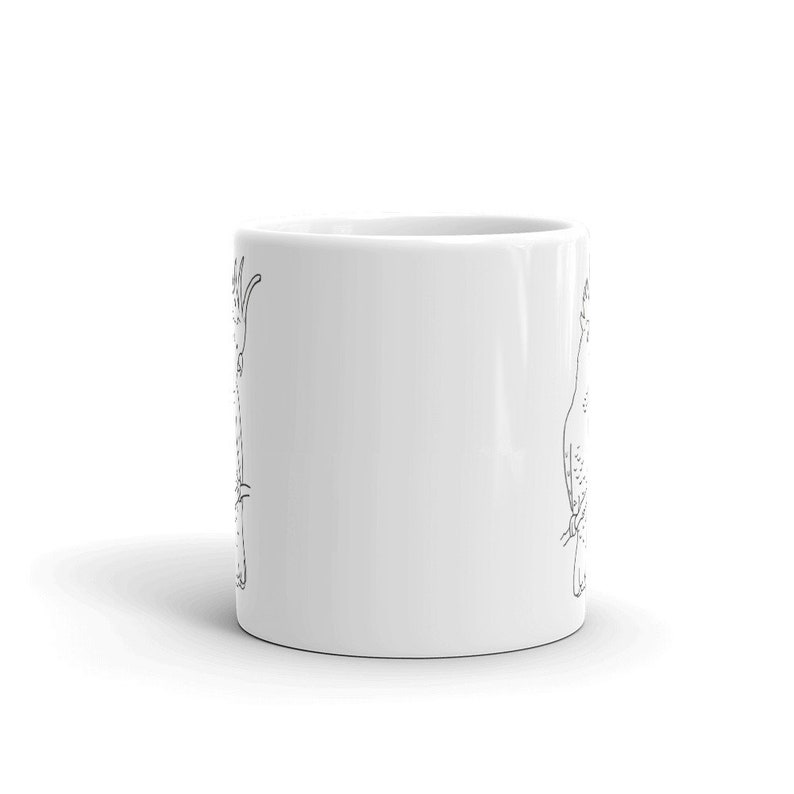 May include: White ceramic coffee mug featuring a black line drawing of a bird. The bird illustration is detailed with visible feathers and a long neck. The mug is cylindrical and has a glossy finish.