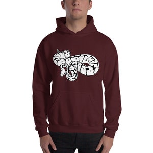 May include: A maroon hoodie featuring a white and black graphic of a snake. The snake design is detailed with a coiled body and a visible head. The hoodie has a front pocket and a hood.