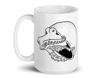 May include: White ceramic mug featuring a black and white illustration of an octopus. The octopus design is detailed, with visible suckers and a dotted head. The mug has a curved handle and a glossy finish.