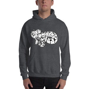 May include: Dark gray hoodie featuring a white and black graphic of a snake. The snake design is centered on the front of the hoodie. The hoodie has a drawstring hood and a front pocket.