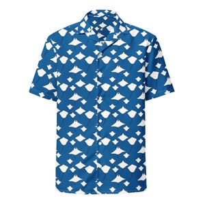 May include: Short-sleeved button-down shirt with a vibrant blue background and a repeating pattern of white manta rays. The shirt features a classic collar and button closure, perfect for casual wear. The design is eye-catching and suitable for a beach or tropical theme.