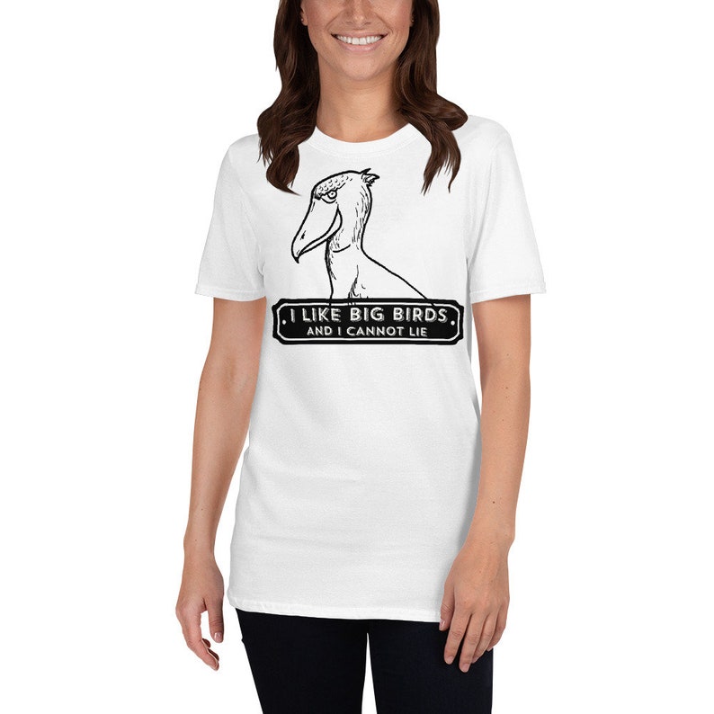 May include: White t-shirt featuring a black and white graphic of a Shoebill bird with the text "I LIKE BIG BIRDS, AND I CANNOT LIE." The shirt is a short-sleeved crew neck.