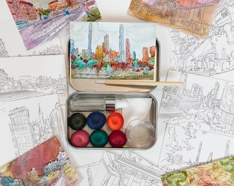 May include: A set of watercolor paints in a metal tin with a brush and a variety of watercolor postcards featuring cityscapes and landscapes. The postcards have the word "HYPEREXIST" printed on them.