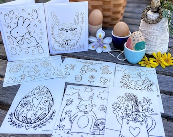 May include: A set of eight black and white coloring pages featuring Easter bunnies, eggs, and other spring-themed illustrations. The pages are printed on white cardstock and are ready to be colored.