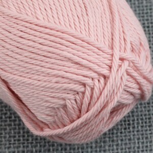 May include: A ball of soft, pale pink yarn.