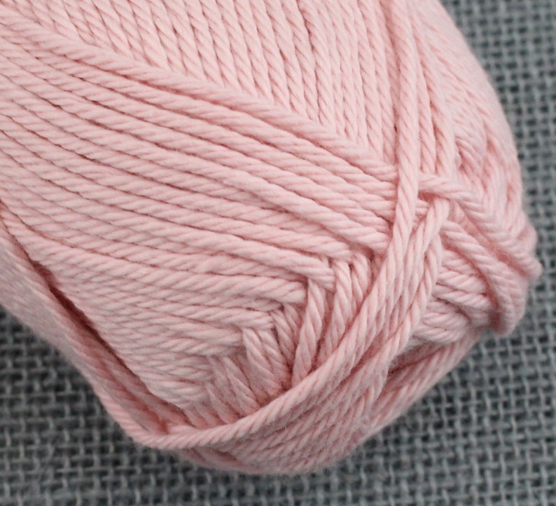 May include: A ball of soft, pale pink yarn.