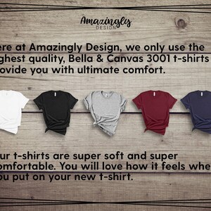 May include: Five Bella & Canvas 3001 t-shirts in white, black, gray, burgundy, and navy blue are displayed on a wooden background. The text reads "Amazingly Design" and describes the shirts as super soft and comfortable.