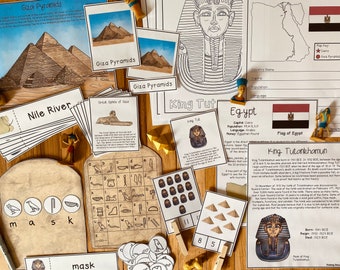 May include: A collection of educational materials for learning about ancient Egypt. The materials include flashcards, a map, a flag, and a hieroglyphics chart. The materials are printed on white paper with black ink. The materials are laid out on a wooden surface.