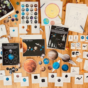 May include: A collection of educational resources for learning about space, including posters, flashcards, and manipulatives. The materials feature images of planets, stars, astronauts, and spacecraft. The text on the materials includes the words "Moon Phases", "The Solar System", "Spacecraft and Space Technology", and "Jupiter".